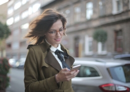 A woman in urban area uses carsharing app as her mobility solution